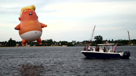 donald trump baby balloon floating above lake at black lives matter protest