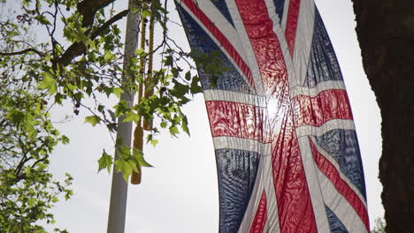 union jack flags hanging along the mall street in london, england, united kingdom