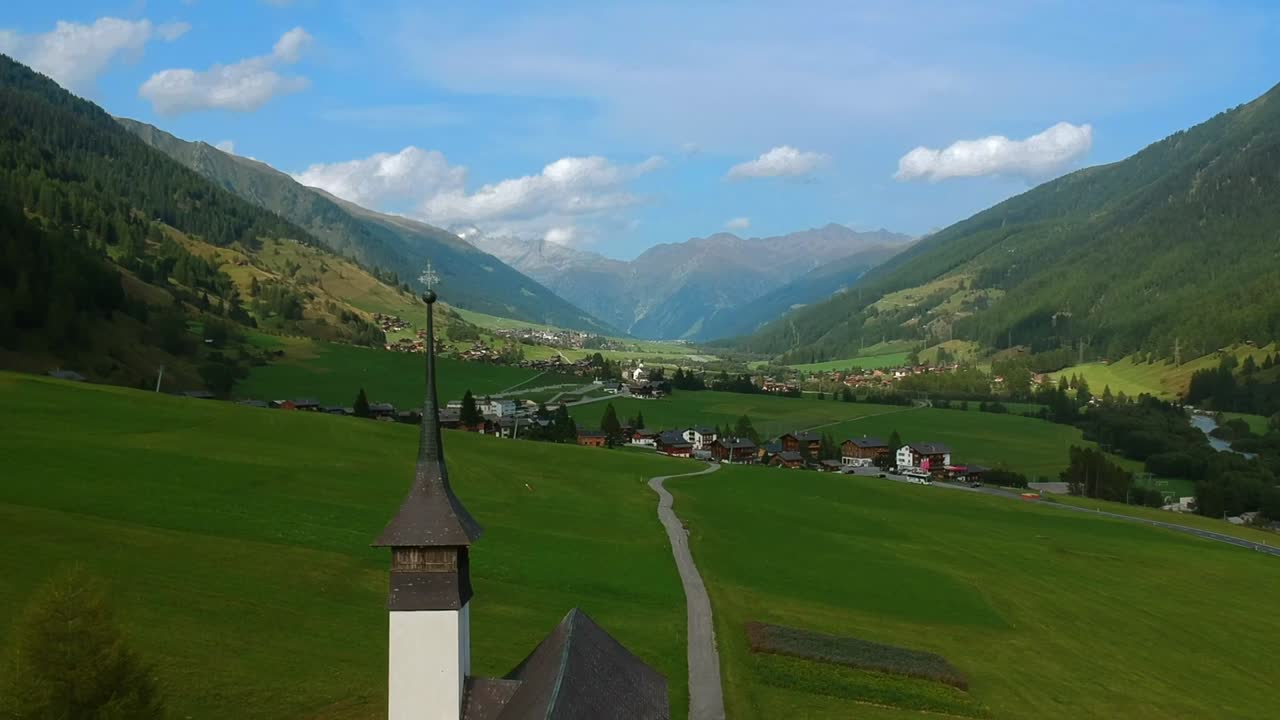 Aerial View of a Charming Alpine Village Nestled in a Picturesque Valley