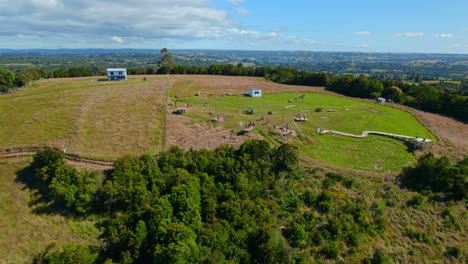 Aerial-Drone-Fly-Dock-Los-Brujos-Lemuy-Island-chilean-Patagonia-Landscape-Green-Meadows,-agricultural-south-American-establishing-shot-above-countryside-fields