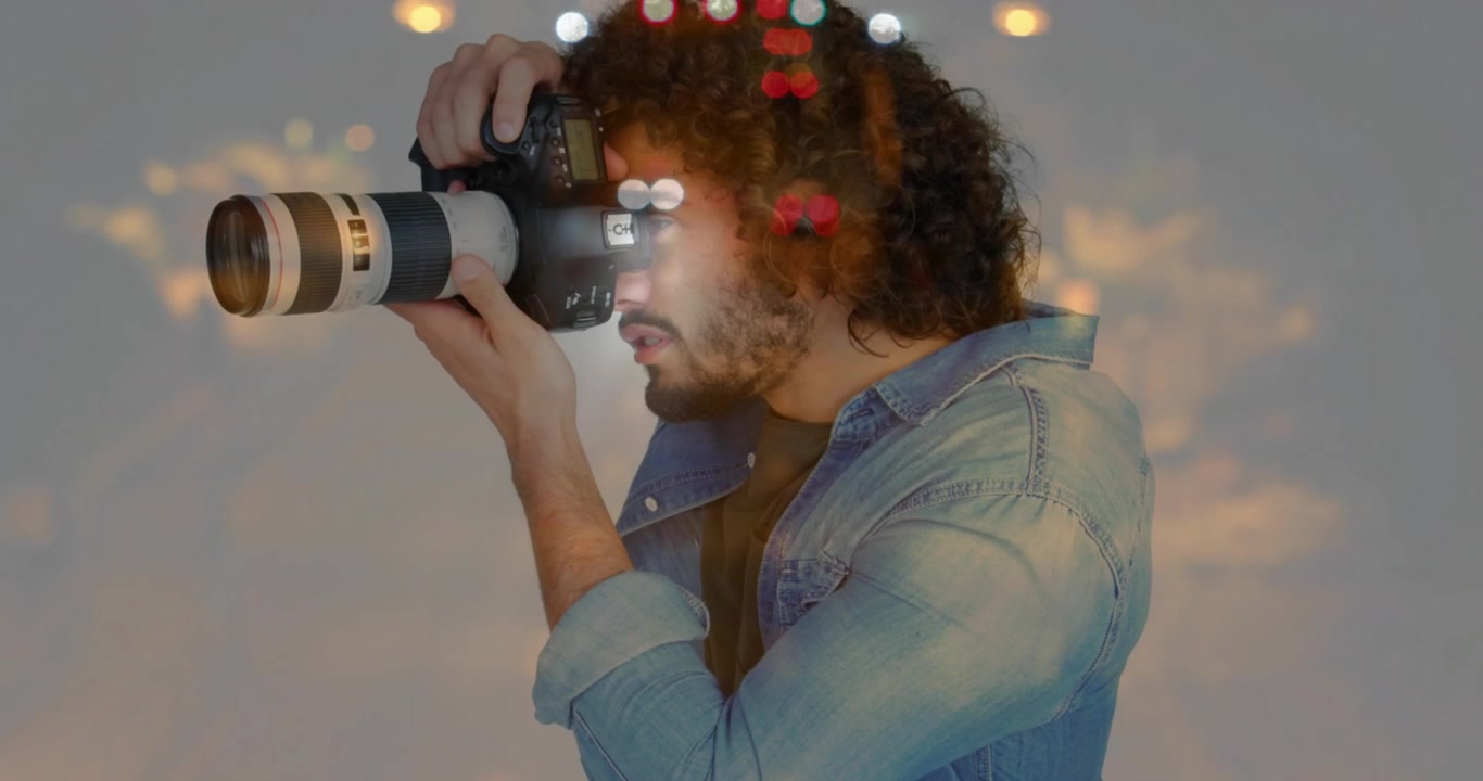 Photographer lifting DSLR showing bokeh traffic patterns framing for technology demo