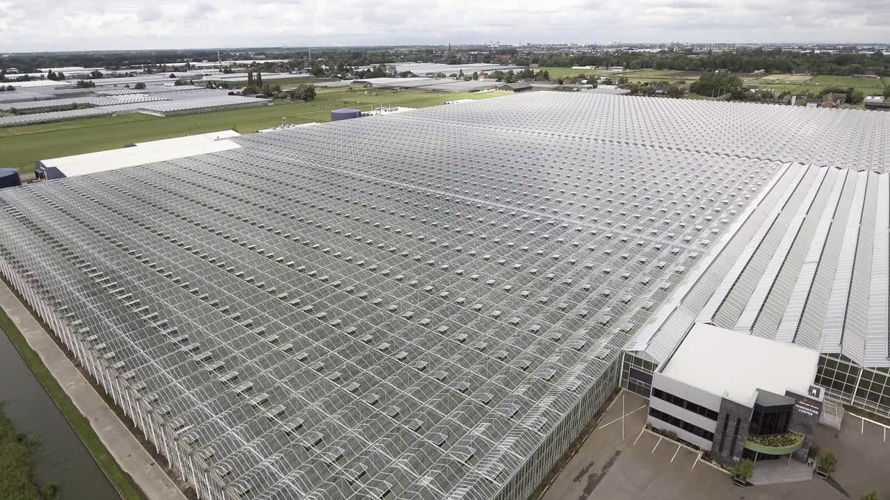 4K Aerial Dolly Forward Shot of big a big Glass Greenhouse farm in the Netherlands.