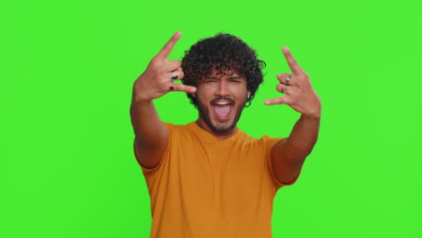 indian man showing rock n roll gesture by hands cool sign crazy expression dancing celebrating