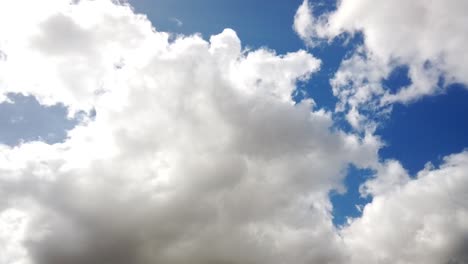 Dark-cloud-timeplapse-with-bright-sunlight-peeking-behind-the-cloud-with-blue-sky