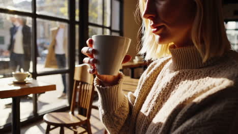 woman enjoying coffee in a cafe with city view