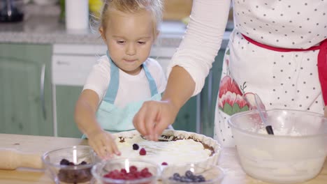 little girl watching the baking with anticipation