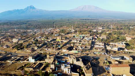 sunrise- kenya landscape with a village, kilimanjaro and amboseli national park - tracking, drone aerial view