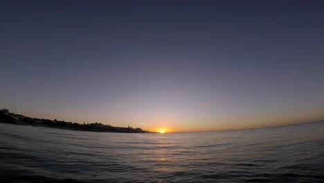 Europe-sunrise-over-Atlantic-waves-and-some-rocks,-Cascais