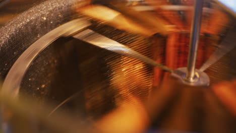 the beekeeper puts frames into honey production machine