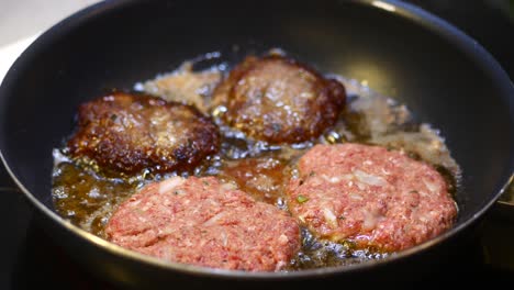 cooking up some juicy meatballs in a frying pan