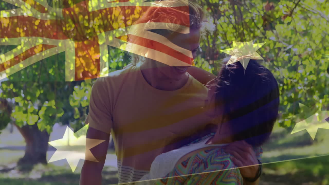 Dancing in park, two people with Australian flag animation in background