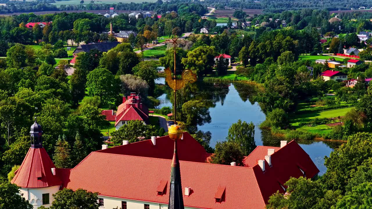 Aerial view over the village of Jaunpils with castle and lake in Semigallia, Latvia