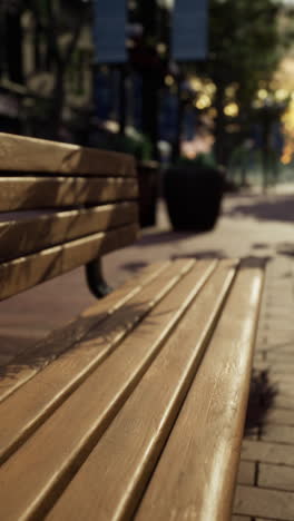 empty wooden bench on a city street