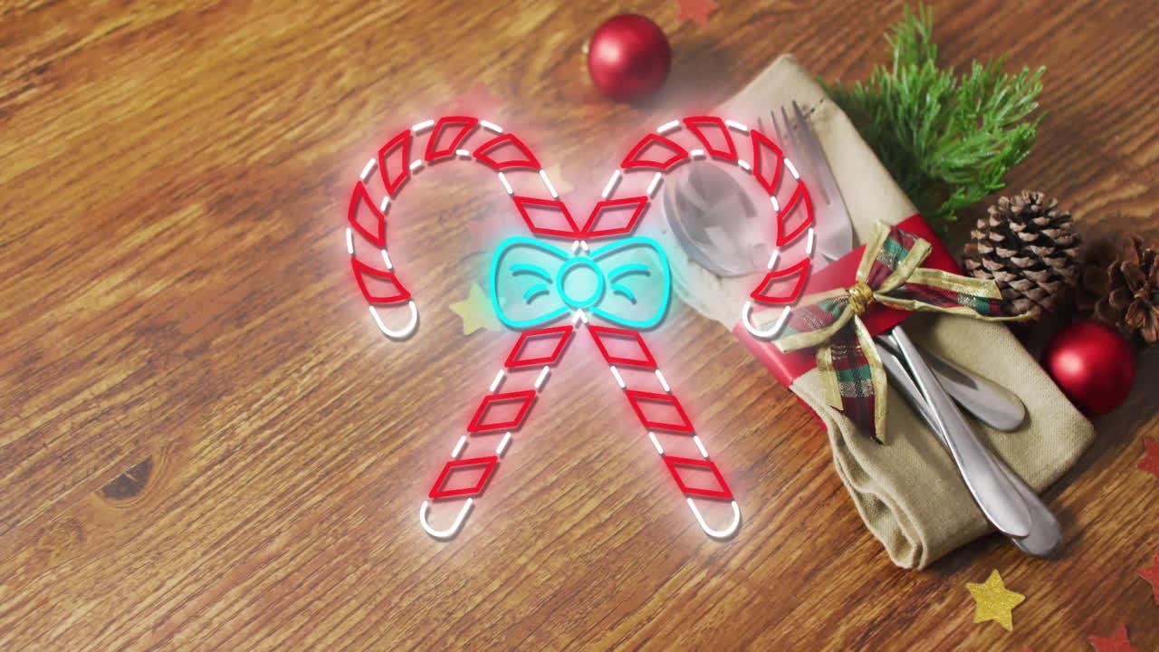 Animation of flickering christmas sugar cain over table setting