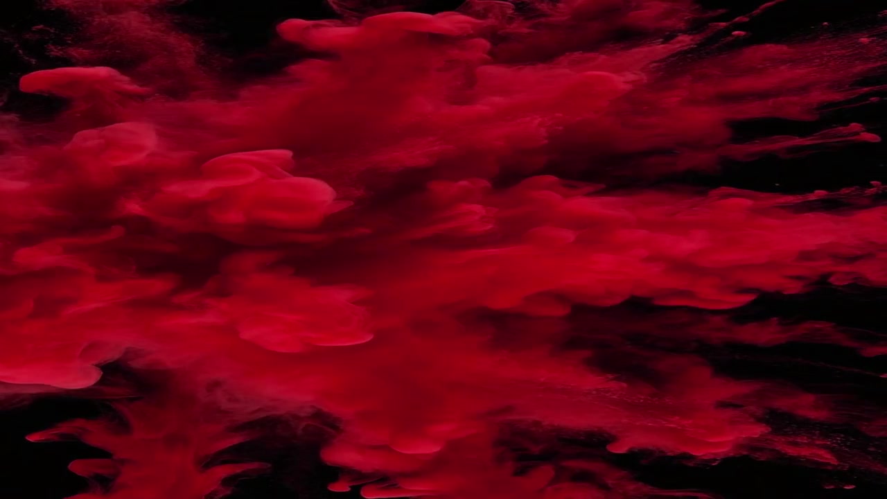 Red Powder Explosion Against Black Background
