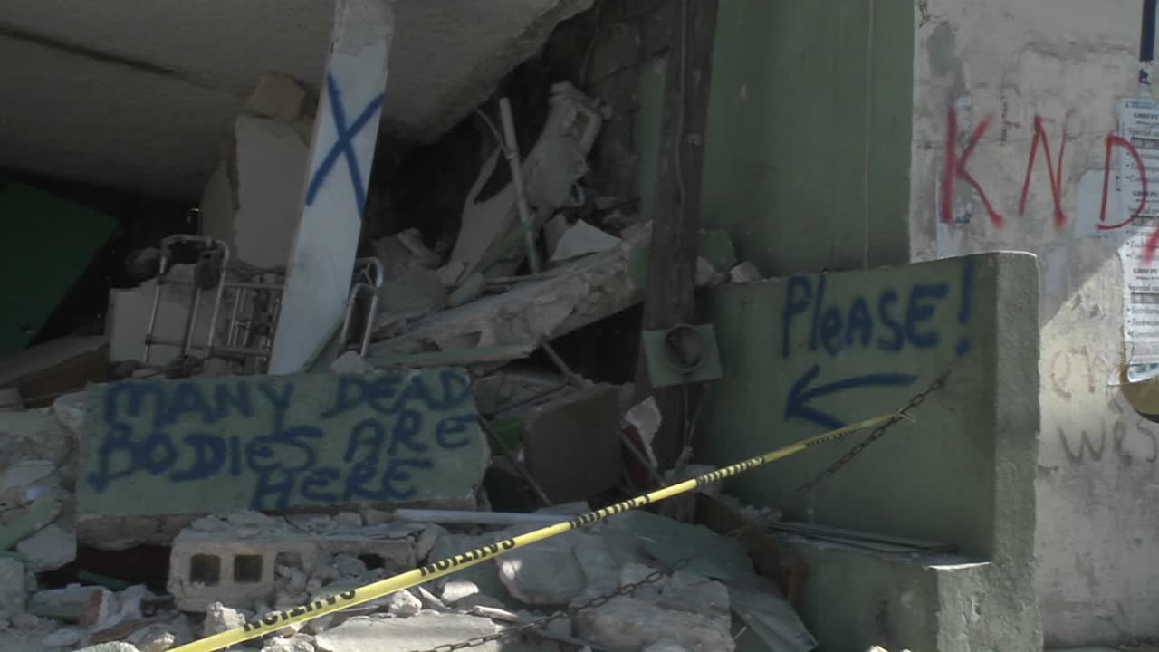 A sign indicates that many dead bodies are here following a terrible earthquake in Haiti