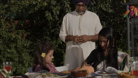 indian family enjoying an outdoor meal together