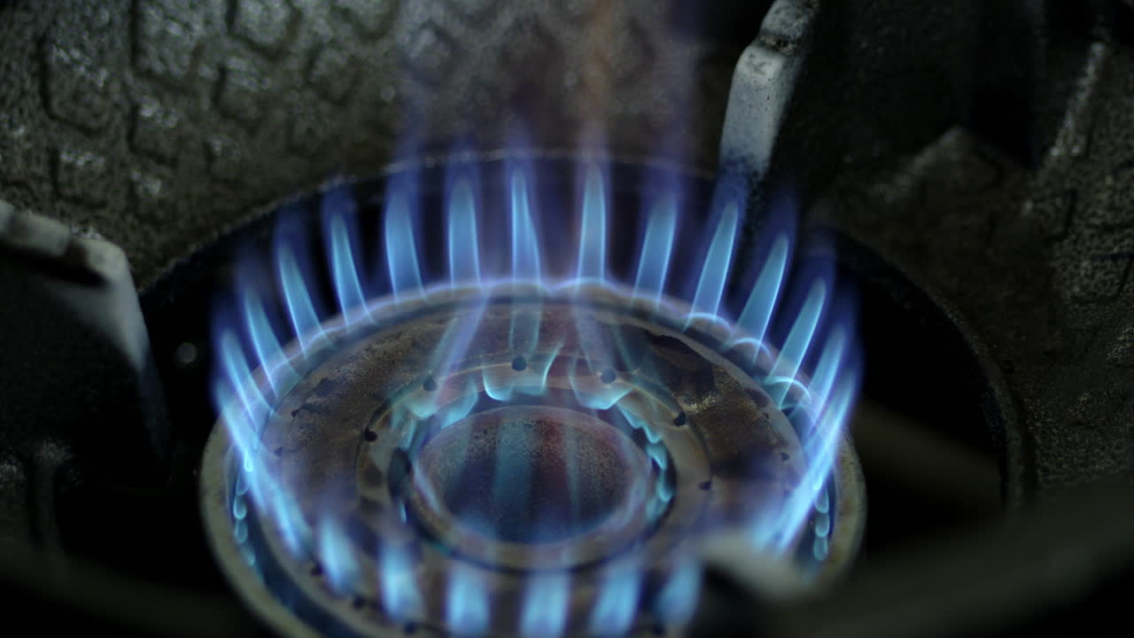 Close-up of a Gas Stove Burner with Blue Flames