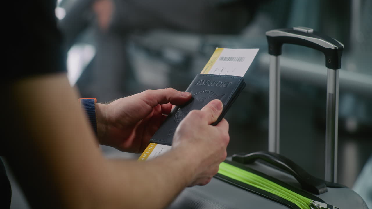 Person holding passport and boarding pass at airport