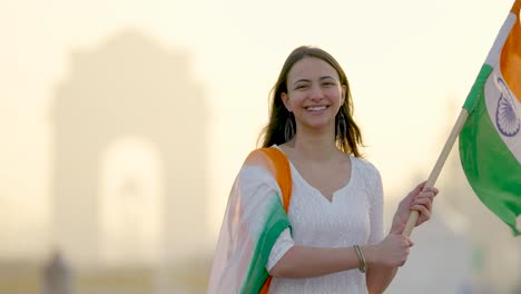 indian woman celebrating indian republic day at india gate delhi by hoisting india flag