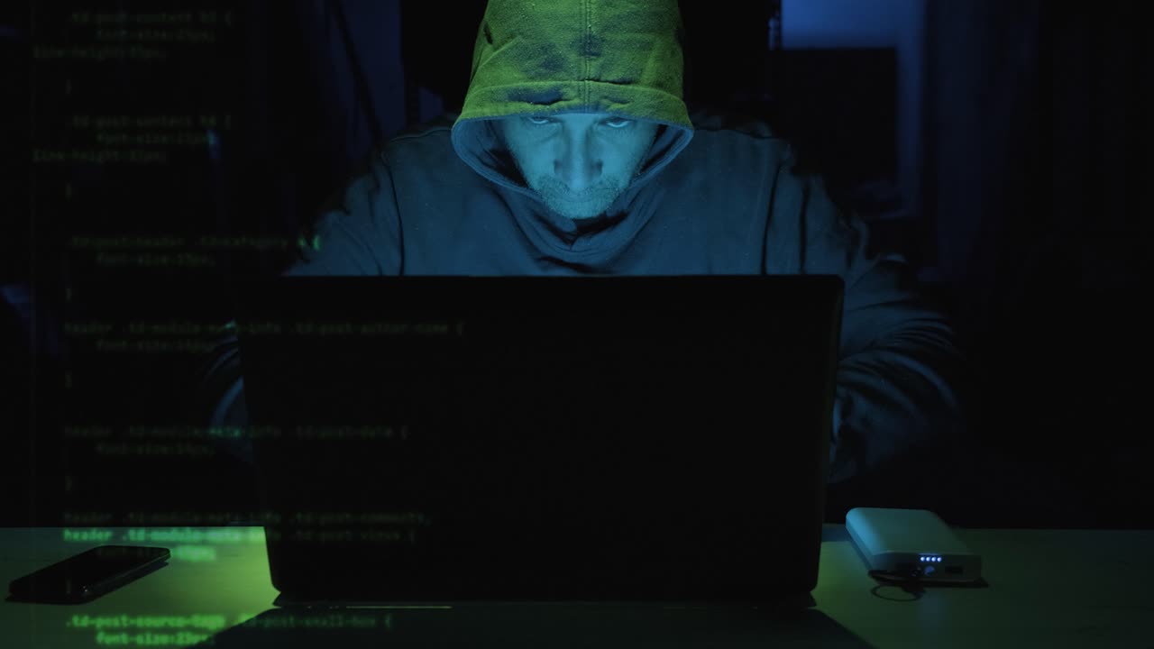 Focus Male Hacker Typing Security Code On Laptop Computer Seen On The Left Side Screen. - close up