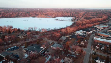 overhead drone shot above frozen minear lake winter from libertyville, illinois, usa sunset aerial 4k