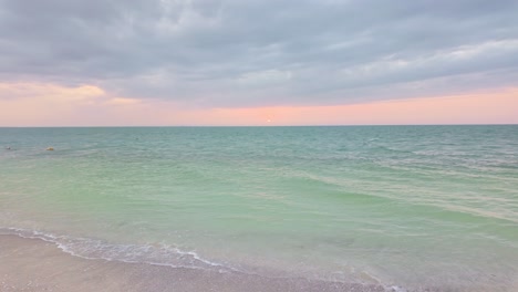 a serene beach scene at holbox punta cocos, mexico, with soft waves and pastel skies