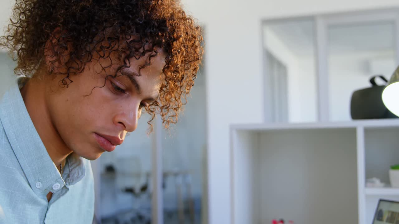 Side view of Caucasian male graphic designer working at desk in office 4k