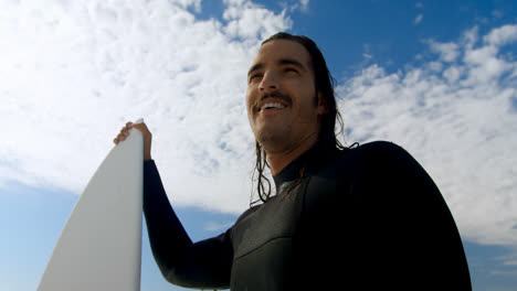 smiling surfer standing with surfboard 4k