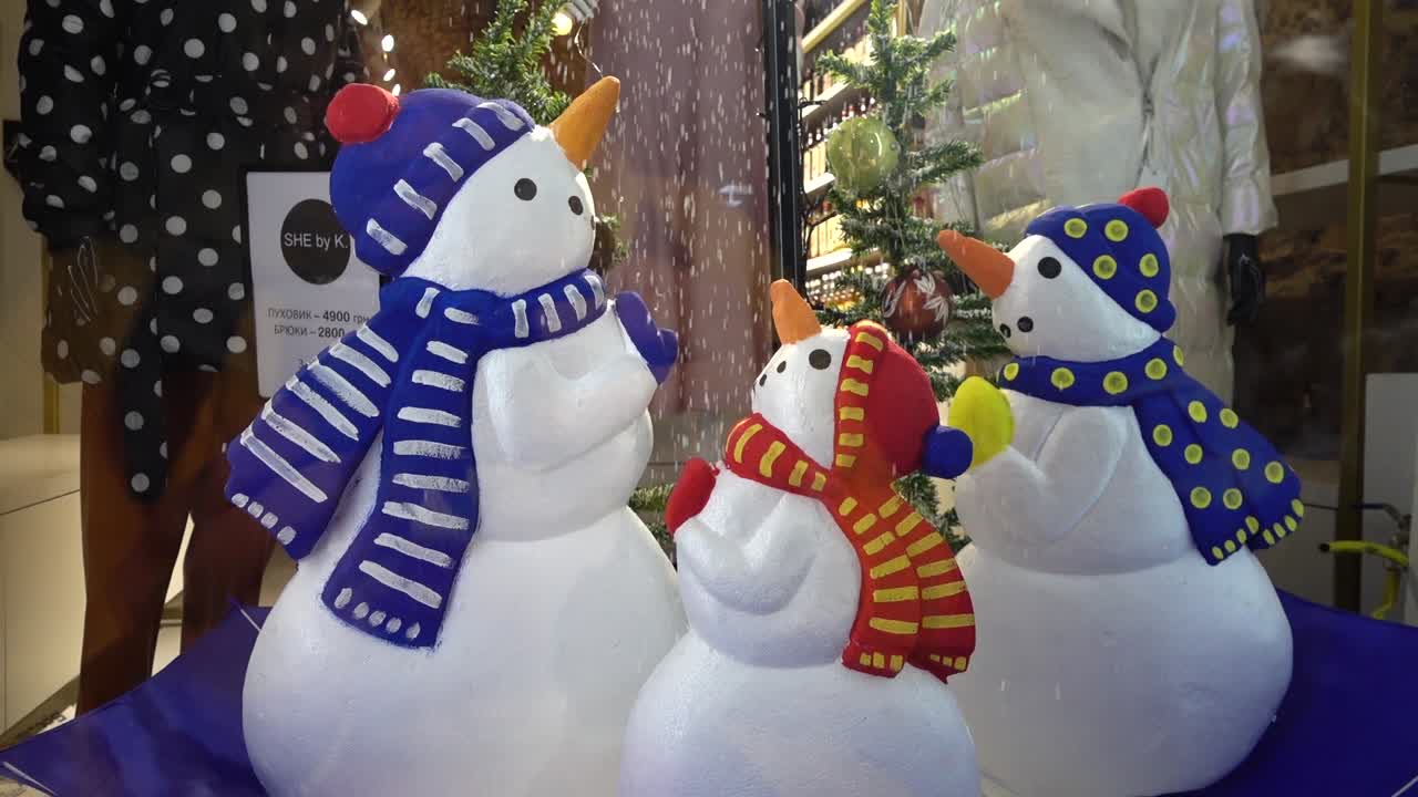 Snowmen in an inverted umbrella