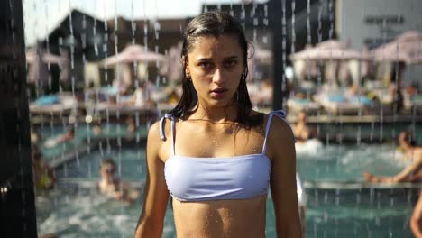 chica adolescente en bikini junto a la piscina