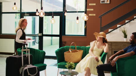 hotel staff talking to guests in lobby