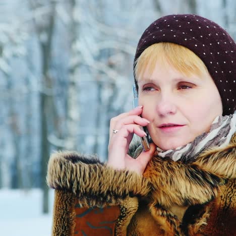 Woman-Uses-Smartphone-In-Winter-Scene-02
