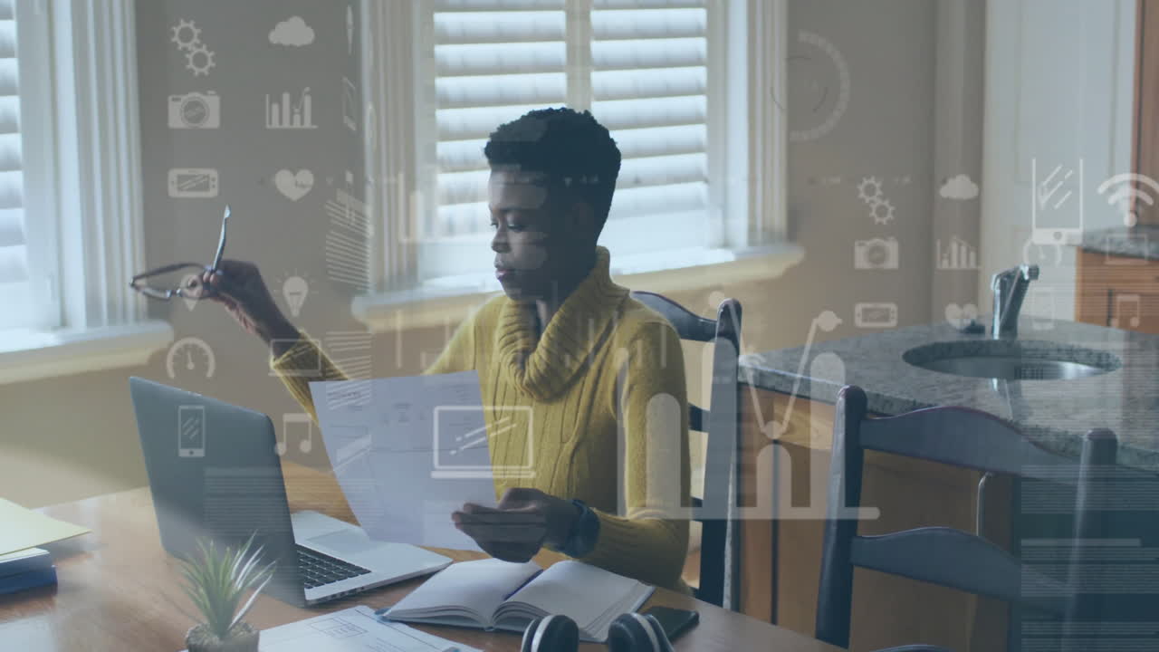 Animation of financial data processing over african american woman using laptop