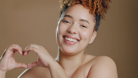 face, skincare and hands with heart sign