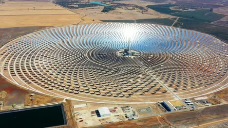 solar panels circular power plants with the reflection of the sunlight in the panels to produce renewable and pollution-free energy - aerial view with a drone - environmental concept