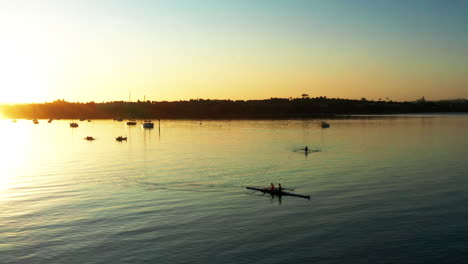 Vibrant-aerial-sunset-above-Auckland-port-with-double-scull-in-forefront