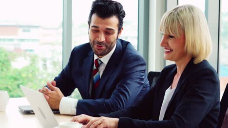 Two-business-people-talk-project-strategy-at-office