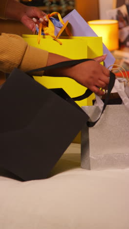 woman shopping, holding bags on a bed