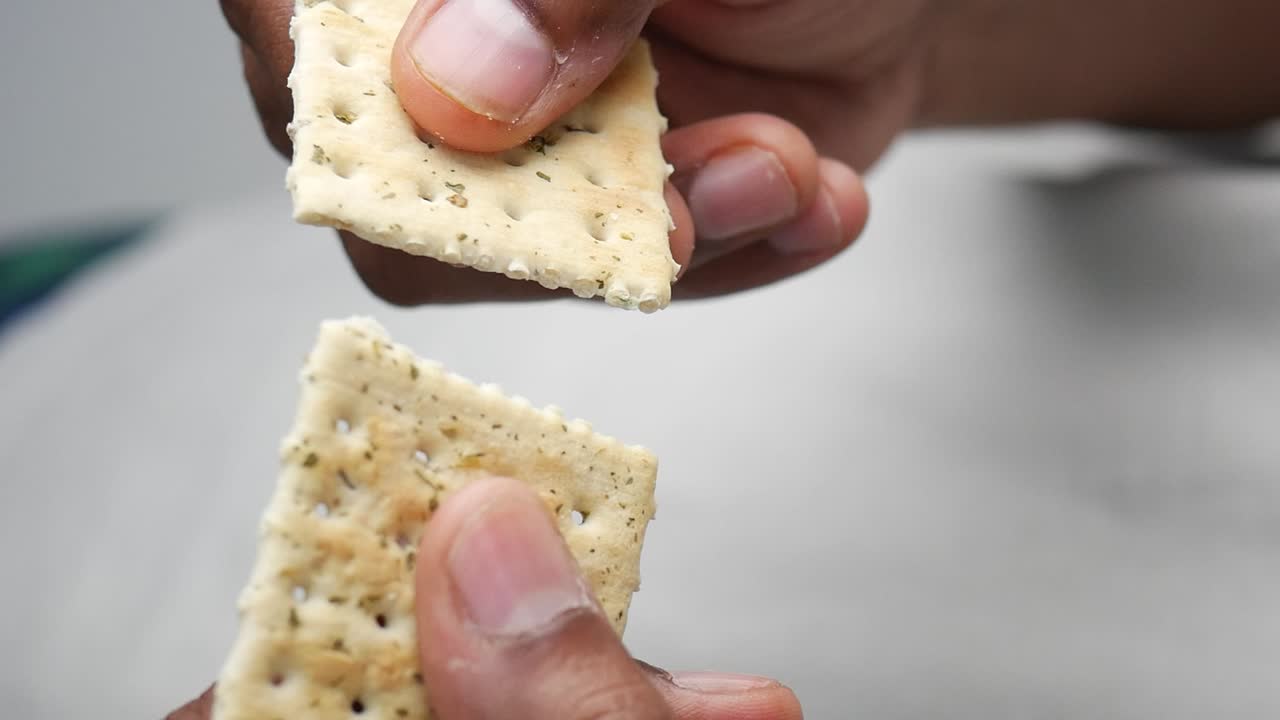 A close-up of crackers being held by a person