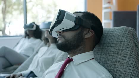 Focused-young-man-in-vr-headset