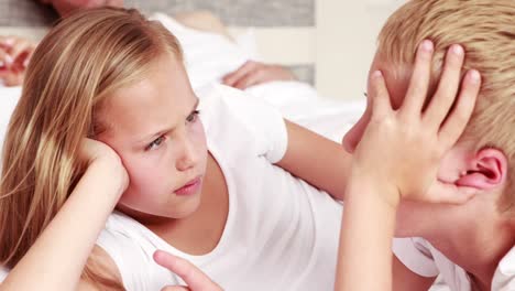 Siblings-talking-on-bed