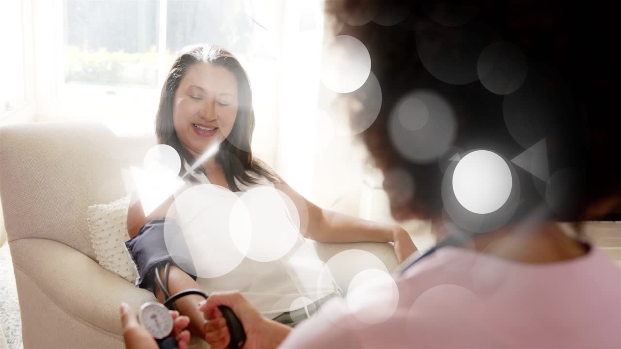 Carer placing cuff, squeezing bulb, monitoring blood pressure for health with bokeh crossing faces