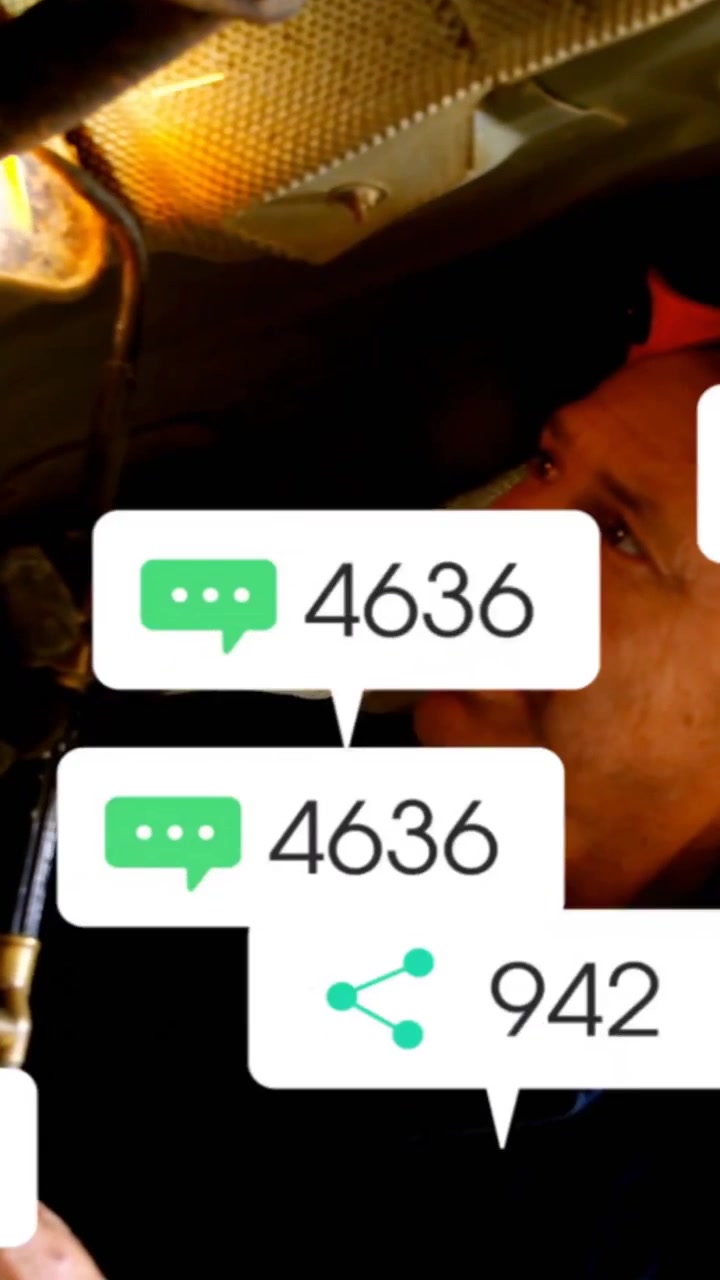 Vertical video: Mechanic checking auto undercar to fix, torch showing parts while new alerts piling