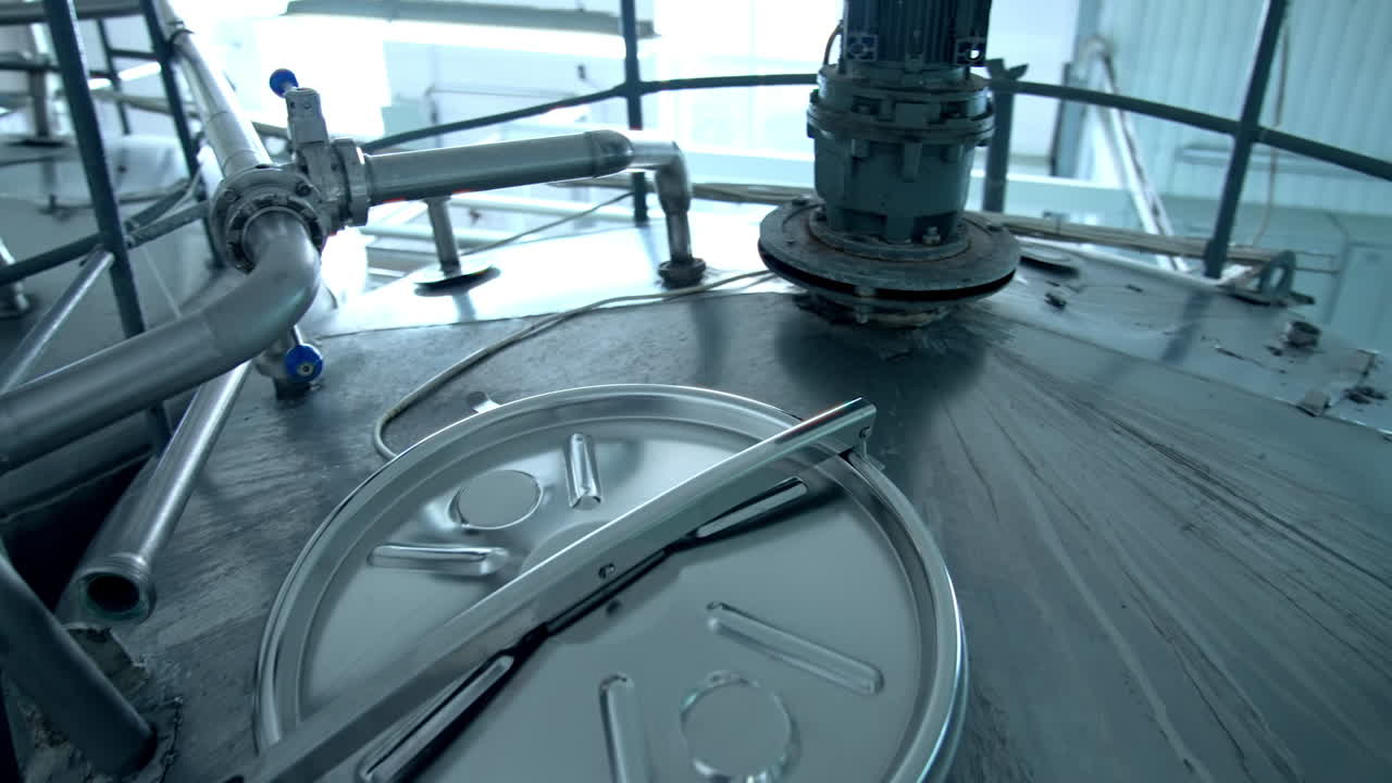 Innovative machinery on a dairy farm. Modern equipment on a milk factory. Metal containers for processing milk products.