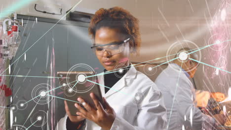 network of connections against female health worker using digital tablet and working at laboratory