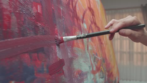 hand holding paint brush and painting