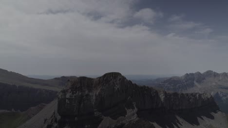 this drone video features a stunning descriptive reverse shot, flying away from the imposing pico del castillo d’acher in the aragonese pyrenees, spain, revealing its breathtaking mountain landscapes.