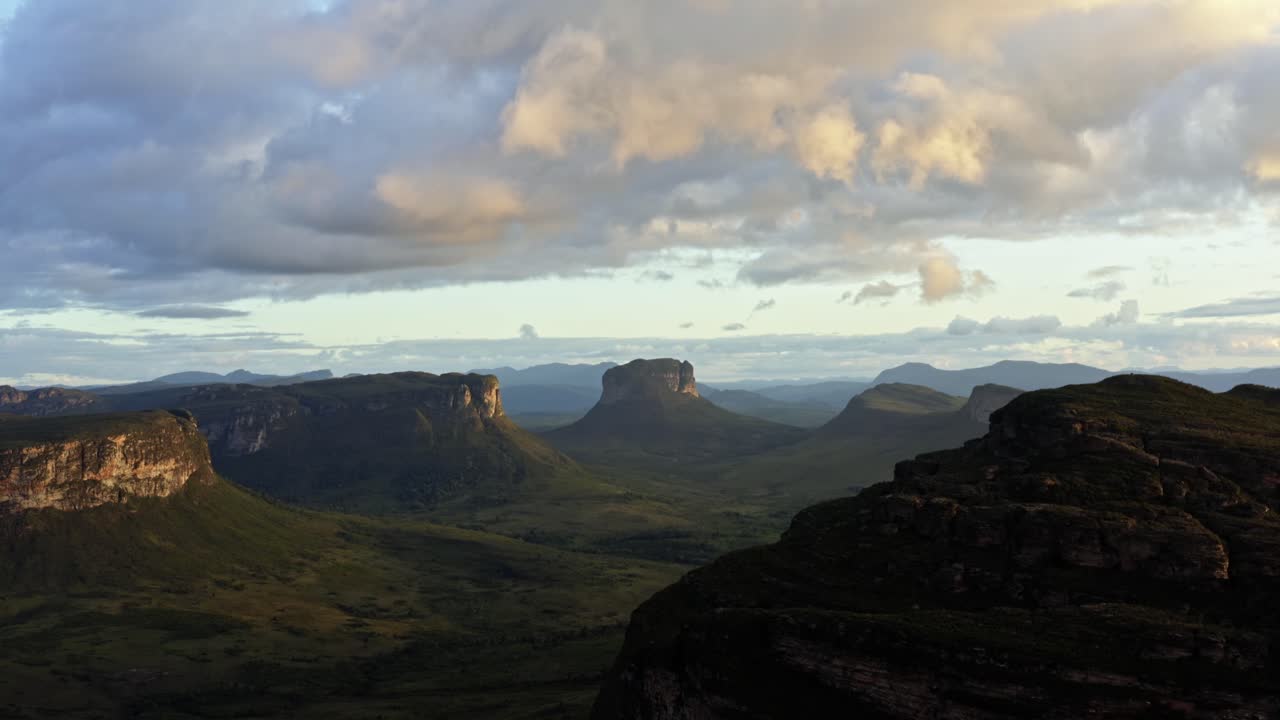 Tilting up flying drone landscape shot of the stunning Capao Valley from the Mount of Pai Inácio in the Chapada Diamantina national park in northern Brazil on a warm sunny summer evening