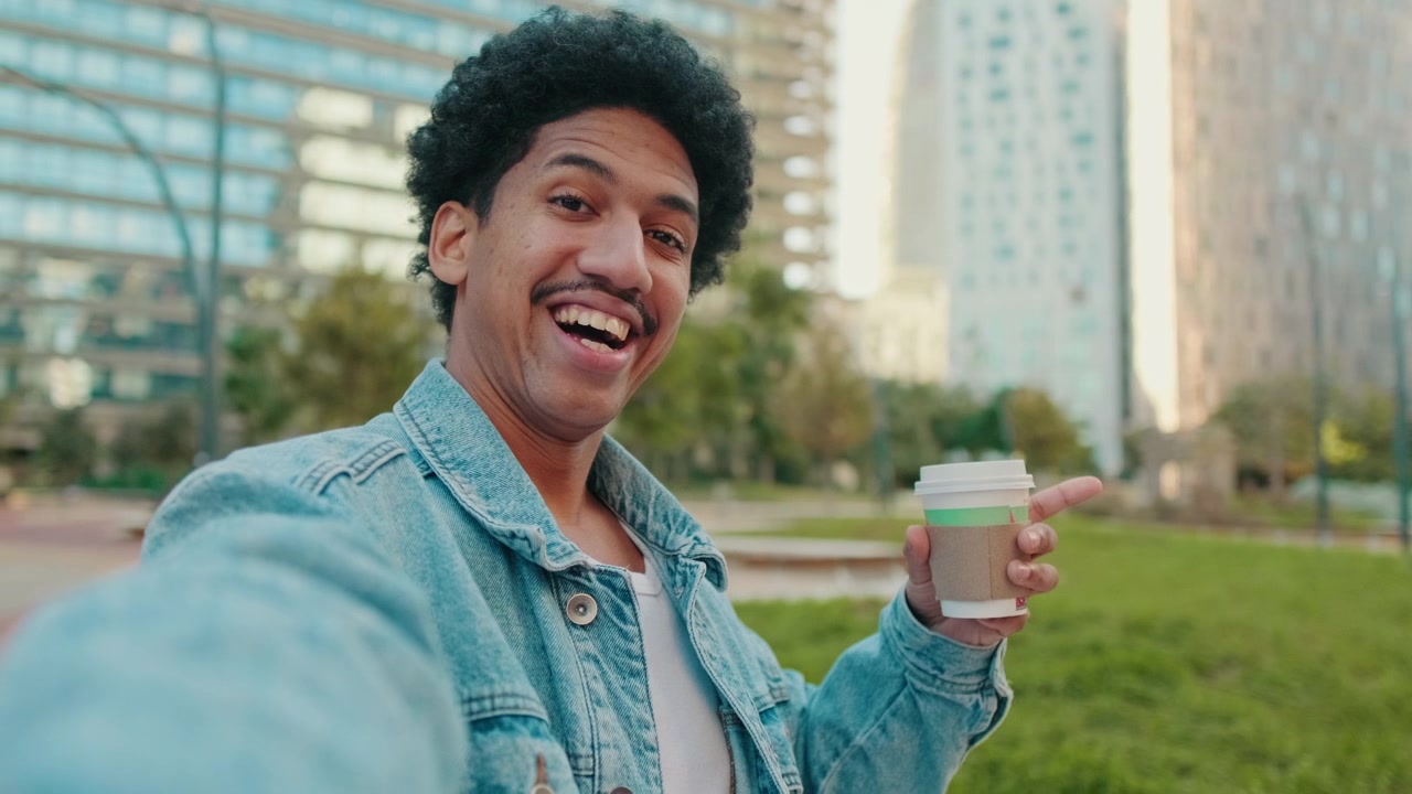 Young Man Recording Selfie Video in Urban Park